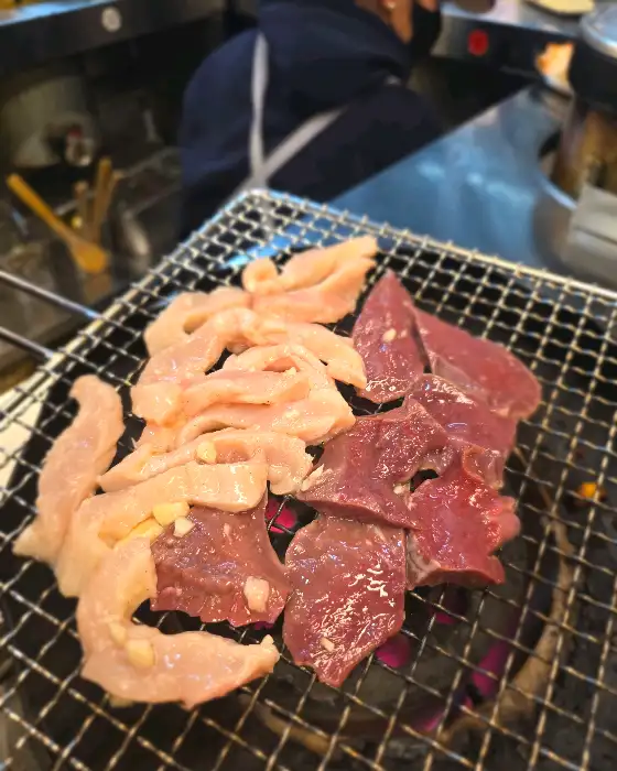 신선한 곱창과 염통이 연탄불 위에 구워지고 있는 모습.
