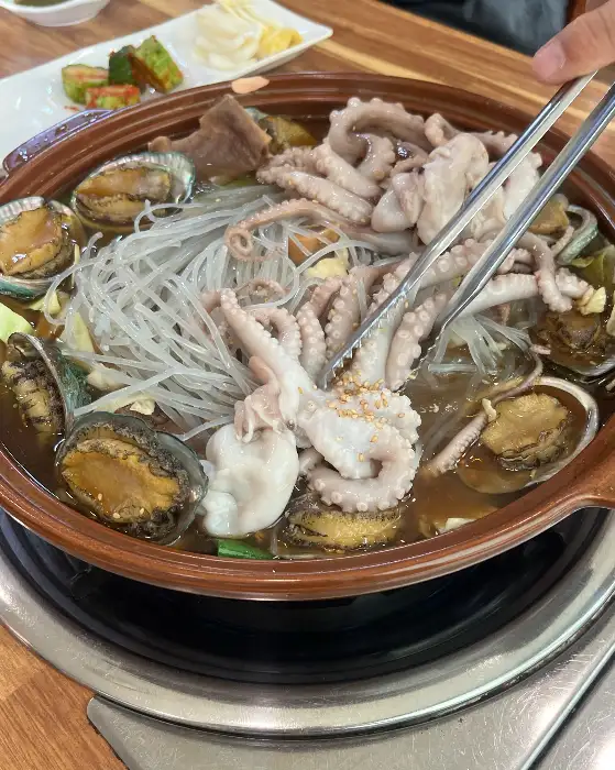 집게로 집어 올린 낙지 다리