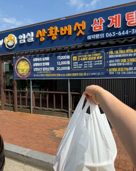 가게 앞 배너와 함께 찍은 사진