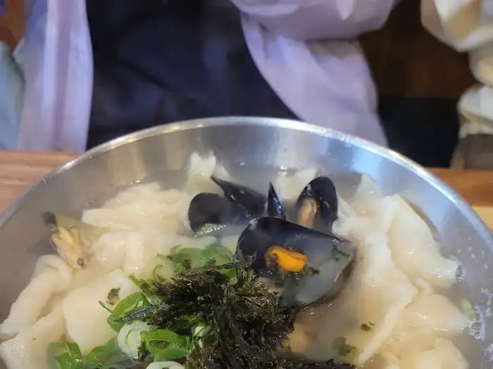 김가루와 파, 그리고 해물이 돋보이는 칼국수 클로즈업