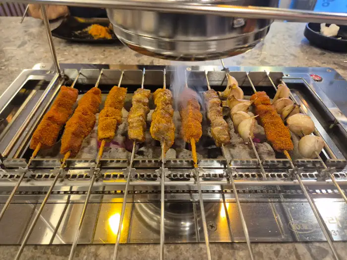 자동으로 돌아가는 양꼬치 기계와 꼬치들