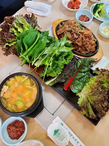 다양한 반찬과 쌈 채소가 놓인 식탁