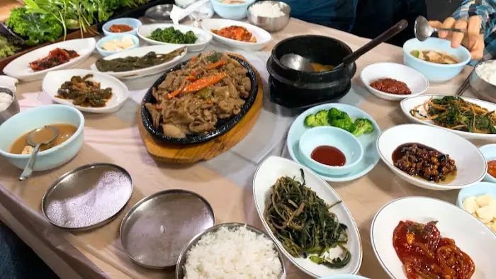 메인 고기 요리와 여러 반찬이 펼쳐진 식탁
